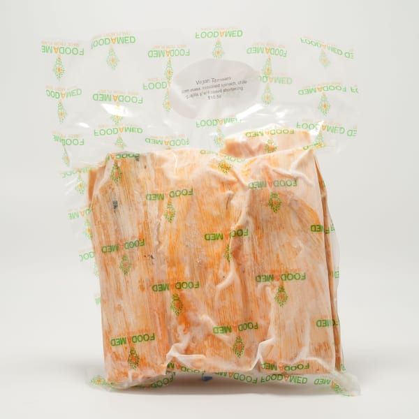 A vacuum-sealed package of Foodamed Vegan Tamales with corn masa, spinach, and chile guajilla.