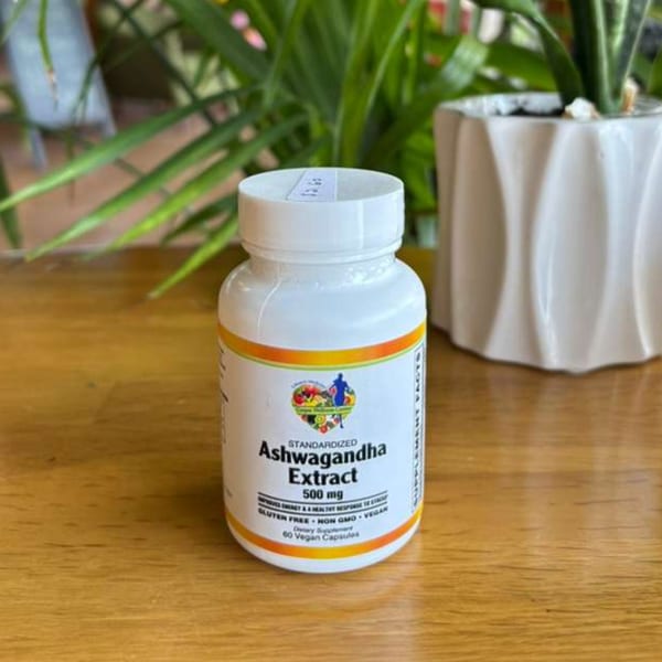 White bottle of "Standardized Ashwagandha Extract 500 mg" with a plant in the background.