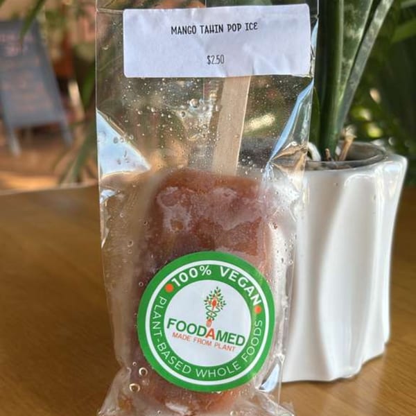 A Mango Tahin Pop Ice from Foodamed, 100% vegan, in clear packaging with a white label.
