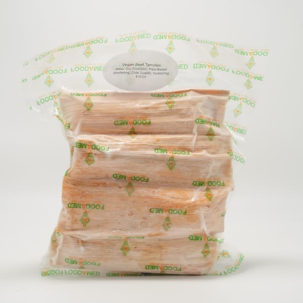 A clear plastic bag of Foodamed Vegan Beef Tamales with a label detailing ingredients and price.