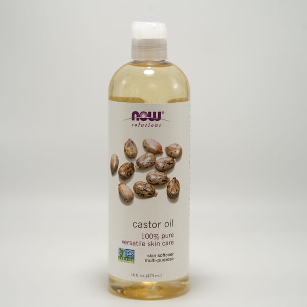 A bottle of Now Solutions 100% pure castor oil for versatile skin care.