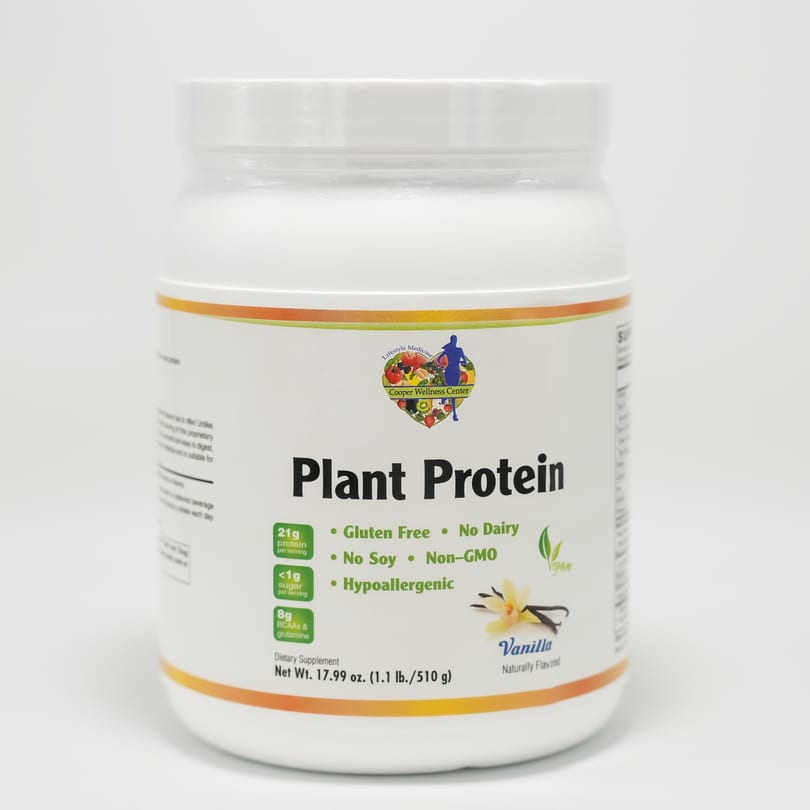 White container of Cooper Wellness Center Vanilla Plant Protein powder on a white background.
