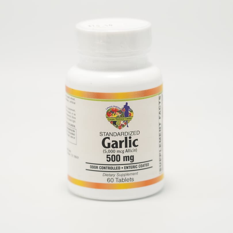 White bottle of Cooper Wellness Center Standardized Garlic 500mg dietary supplement with 60 tablets.