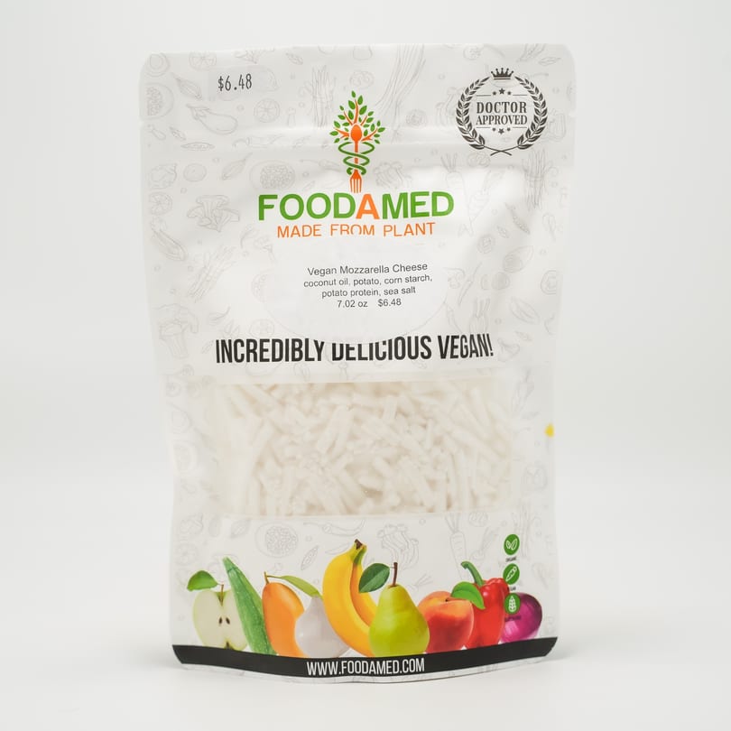 Foodamed vegan mozzarella cheese in a clear package with fruit and vegetable illustrations.